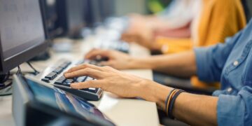 A customer service person working on a computer at a corporate service desk