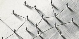 A group of people interlinked demonstrating how a social network works