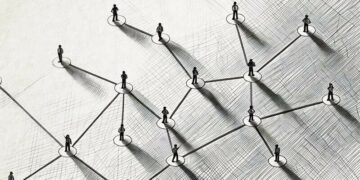 A group of people interlinked demonstrating how a social network works