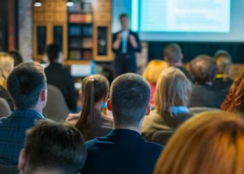 Person giving sales presentation and nailing it in front of engaged audience