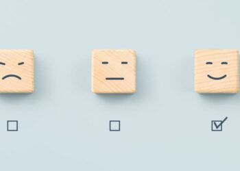 A series of symbols depicting standard customer service feedback icons with the positive smiley face ticked