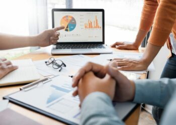 People in a meeting, looking at the computer and making a marketing strategy for their business.