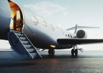 A private jet sitting on the tarmac with a door open