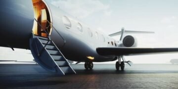 A private jet sitting on the tarmac with a door open