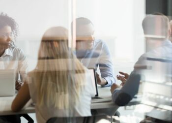 Team of people in a meeting representing the making of the customer service strategy.