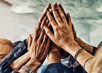 A team of people high fiving as a creative winning team.