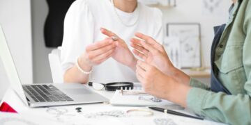 Woman showing a man a test ring upon starting a jewellery business.