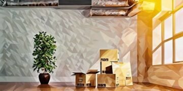 Packed boxes and a plant in an empty office space ready to be moved to the new office.