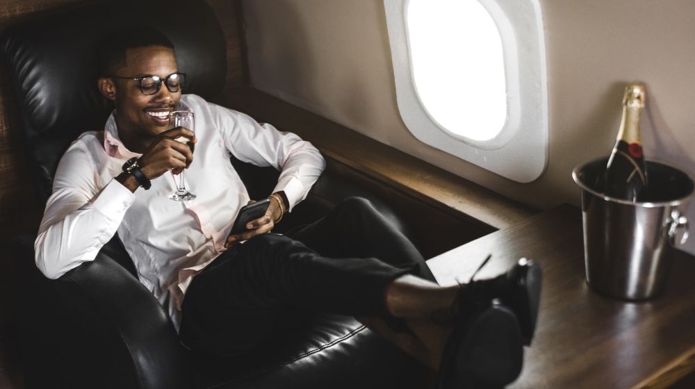 An entrepreneur sitting in a private jet he's chartered with crypto currency