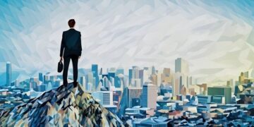A business man standing on the top of a mountain looking down on a metropolitan city - Showing vision, courage and growth