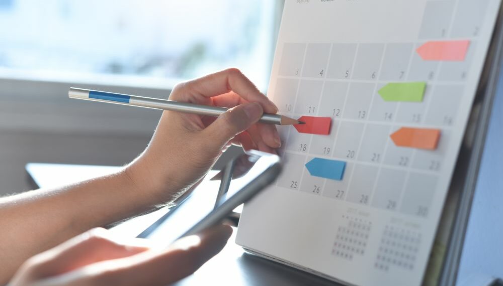 A person using a board to schedule themselves