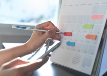 A person using a board to schedule themselves