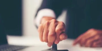 A program director stamping an approval on a IT certificate for the student that passed