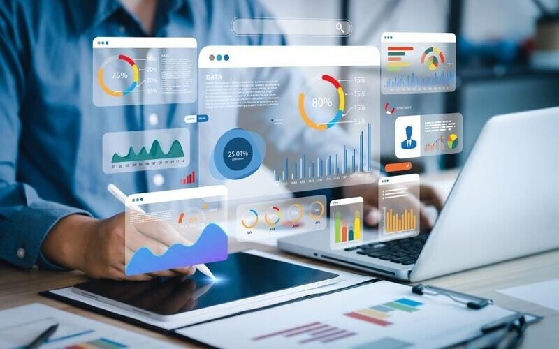 A starutp advisor reviewing all the key metrics of a startup via his laptop using a number of AI analytical tools