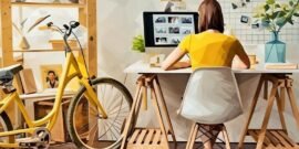 A freelancer working next to her bike in a tiny apartment but with great home office setup