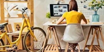 A freelancer working next to her bike in a tiny apartment but with great home office setup