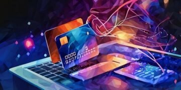 A series of credit cards flying above a laptop