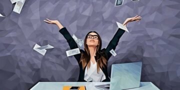 A women throwing papers up in the workplace with happiness, demonstrating a eureka moment of realisation