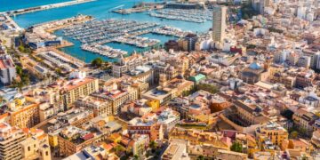 Alicante city panoramic aerial view with seaside, harbour and houses. Spanish city with beautiful beach. Travel and holidays concepts with a popular European summer destination.