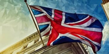A british flag swaying in the win on a classic stone London building