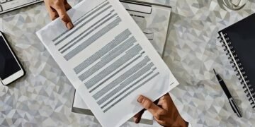 Two workers exchanging a paper contract