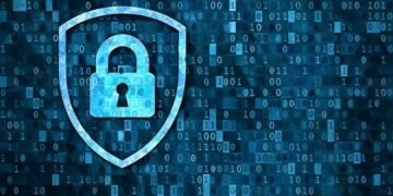 A shield with a lock on it infront of digital code
