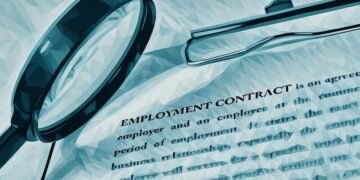 An employment contract with a magnifying glass over it