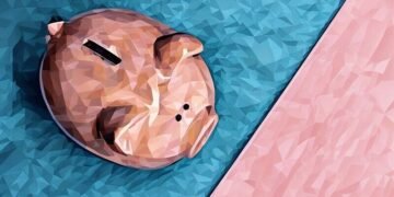 A piggybank sitting over blue and pink background