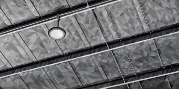 The top of a commercial office, with low energy consumption lights hanging from the ceiling