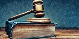 A legal gavel sitting on top of a British commercial law book