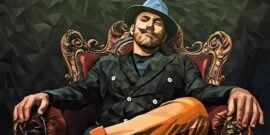 A man with a prominent mustache and being well dressed sitting in a modern kings chair