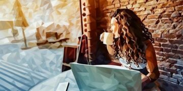 A person drinking coffee whilst remote working and look outside the coffee shop