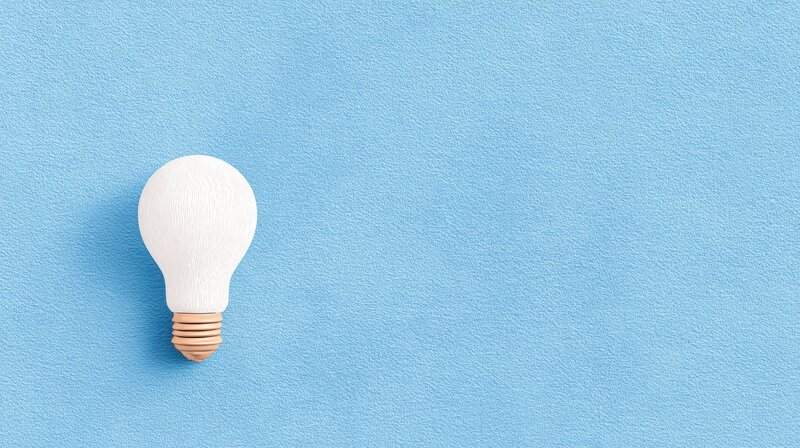 A blue background with a single lightbulb lit up on the left, as an example for a great idea coming from nothing